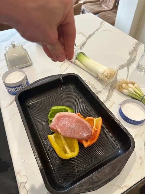 Pork steaks and peppers in oven tray
